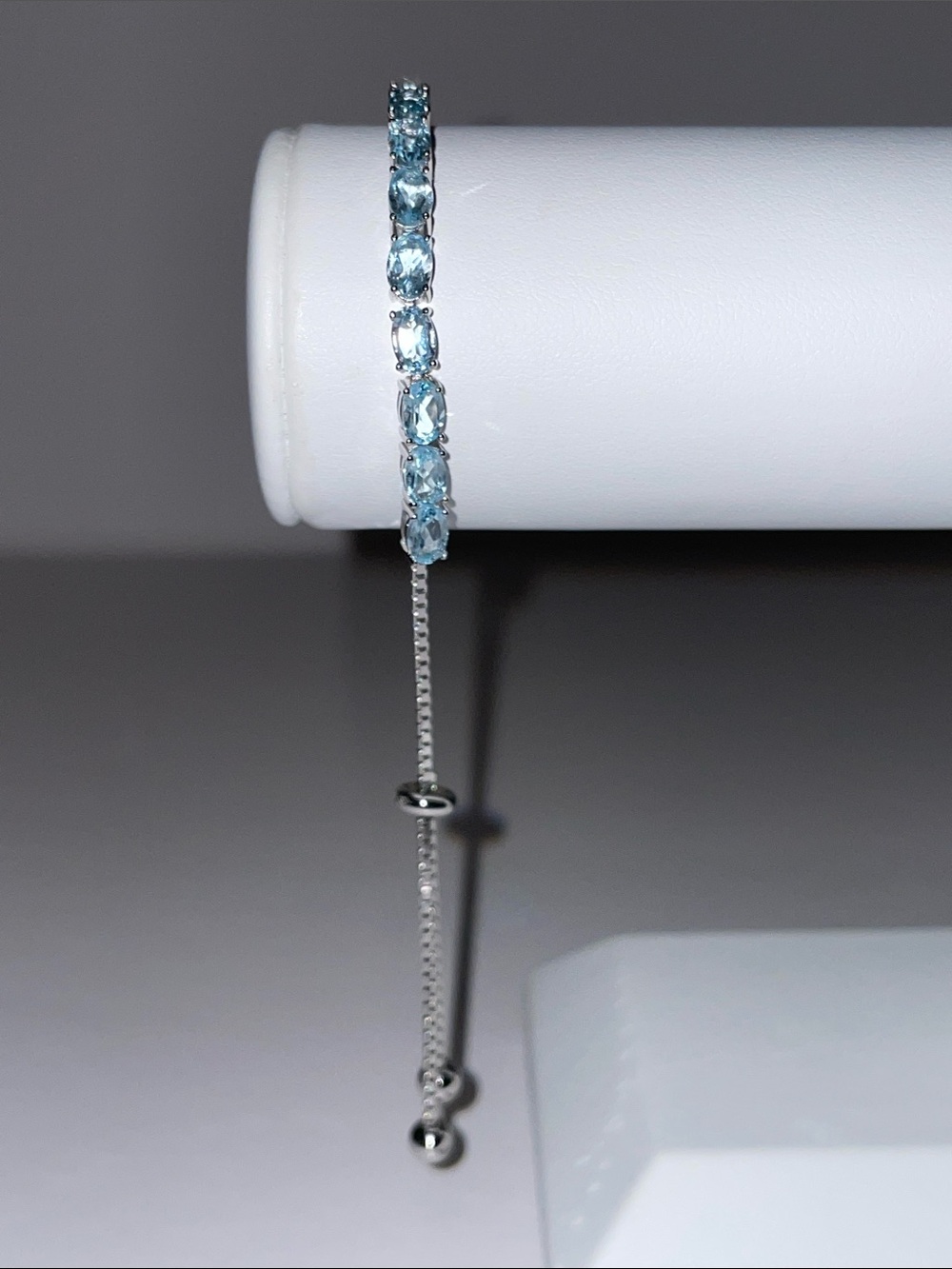 Blue Topaz Tennis Bracelet In Rhodium Plate Sterling Silver With Adj. Bolo Clasp